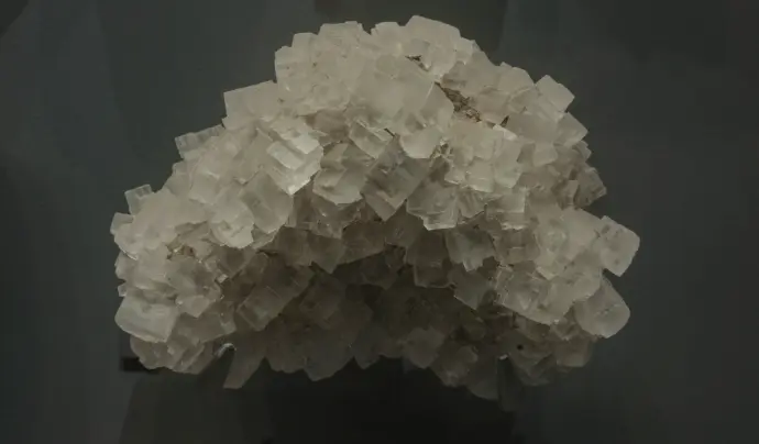 A cluster of salt crystals in focus.